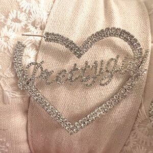 The earrings say Pretty Girl